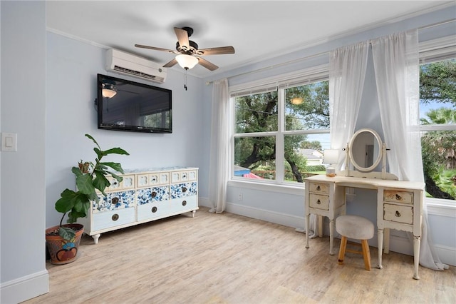 home office featuring plenty of natural light, ceiling fan, light wood-type flooring, and a wall unit AC