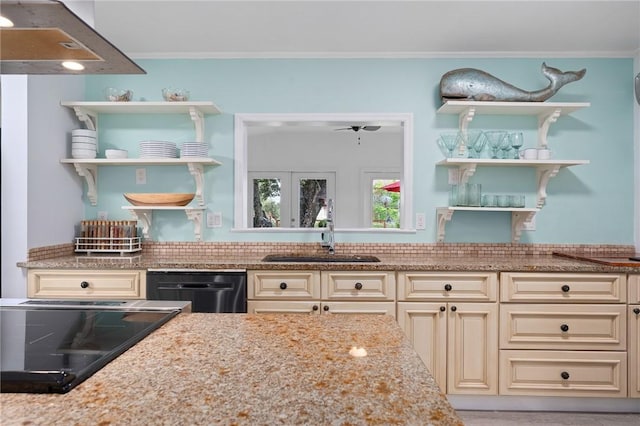 kitchen featuring light stone counters, crown molding, sink, cream cabinets, and black dishwasher