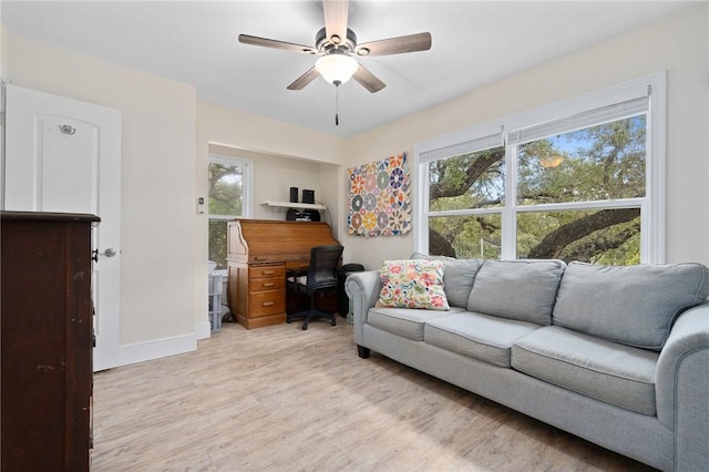 living room featuring ceiling fan and light hardwood / wood-style flooring