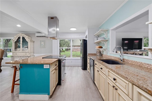 kitchen with light stone counters, a kitchen island, sink, and stainless steel appliances