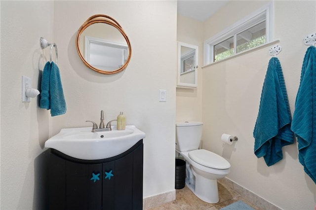 bathroom with tile patterned floors, vanity, and toilet