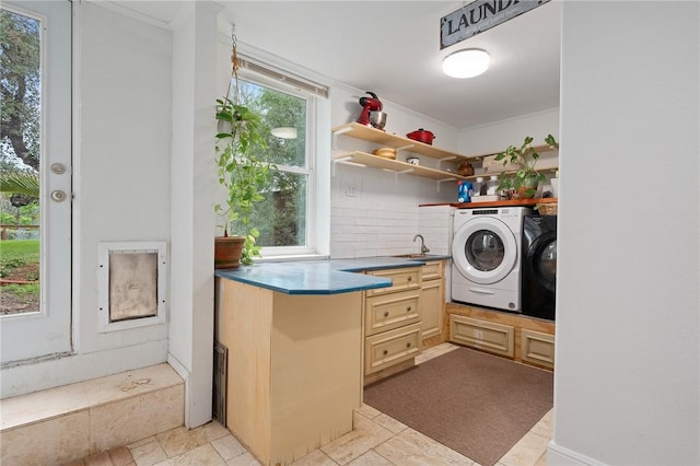 laundry area with sink and washing machine and clothes dryer