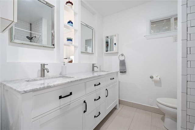 bathroom featuring tile patterned floors, vanity, and toilet