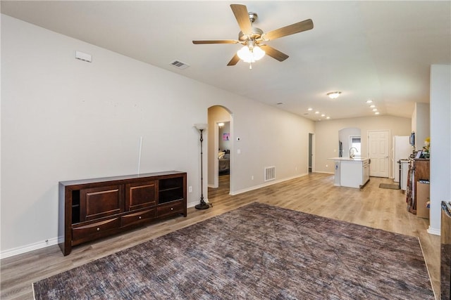 1517 Dorado St, Corpus Christi, TX 78417 - unfurnished living room featuring arched walkways, ceiling fan, light wood-style flooring, and recessed lighting