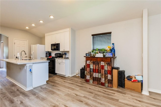 1517 Dorado St, Corpus Christi, TX 78417 - kitchen with black appliances, white cabinets, light wood finished floors, a center island with sink, and lofted ceiling