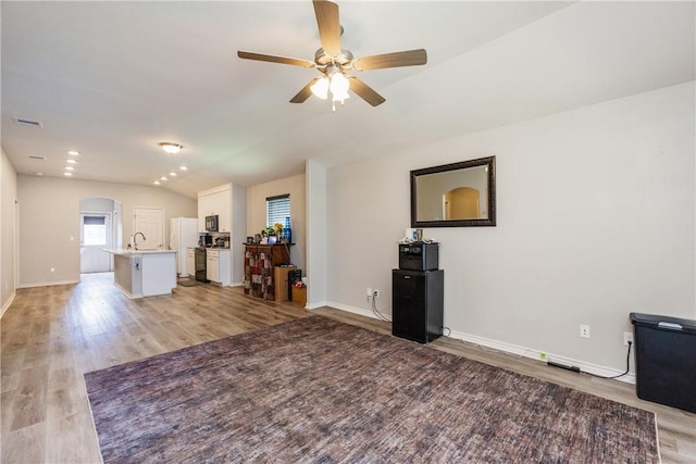 1517 Dorado St, Corpus Christi, TX 78417 - living area featuring a ceiling fan, light wood finished floors, arched walkways, and lofted ceiling