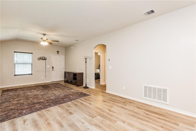 1517 Dorado St, Corpus Christi, TX 78417 - unfurnished living room with arched walkways, light wood-style floors, a ceiling fan, and vaulted ceiling