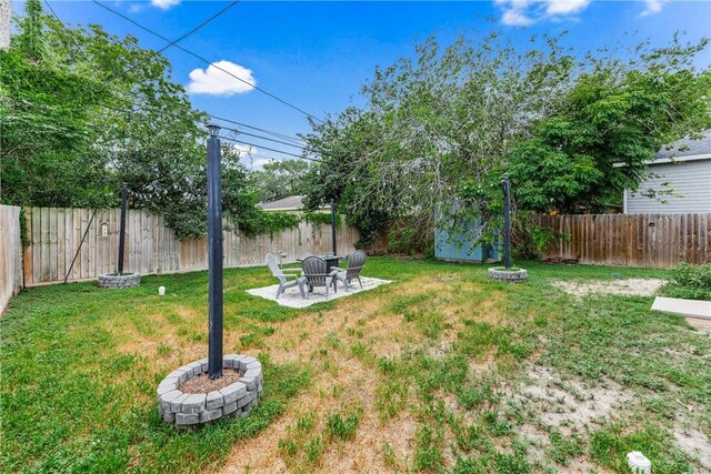 1517 Dorado St, Corpus Christi, TX 78417 - fenced backyard featuring a patio and a shed