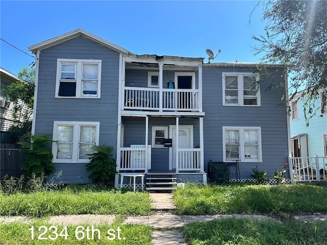 view of front of home featuring a balcony