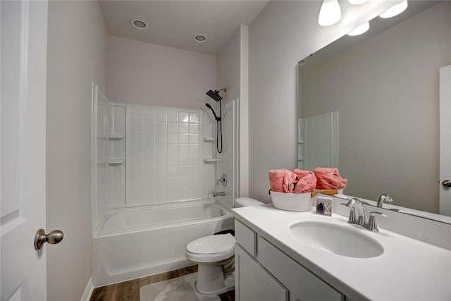 full bathroom featuring vanity, hardwood / wood-style floors, shower / tub combination, and toilet