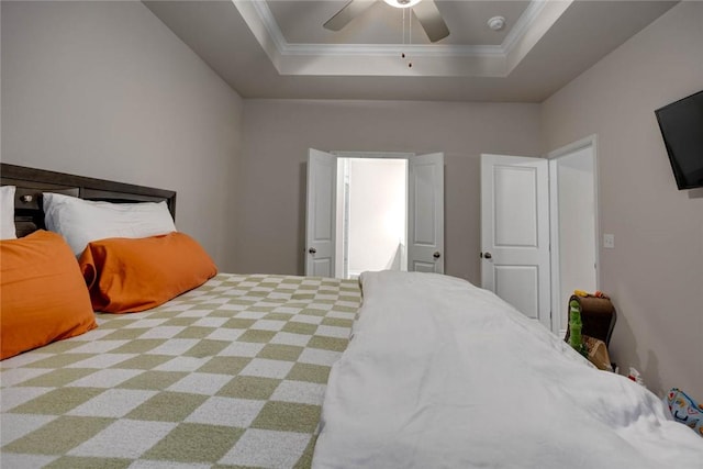 bedroom featuring crown molding, ceiling fan, and a tray ceiling