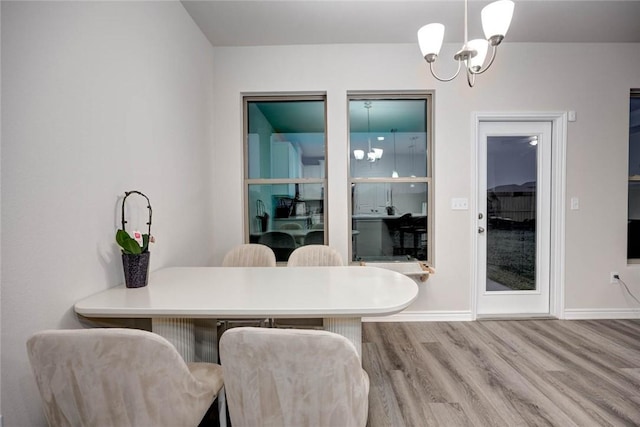 dining room featuring hardwood / wood-style floors and a notable chandelier