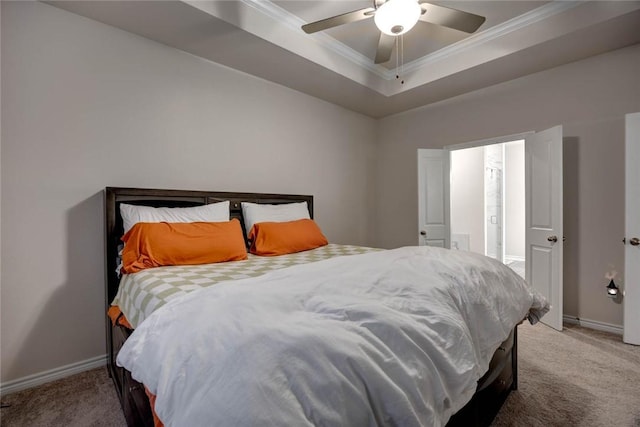 bedroom with a raised ceiling, ornamental molding, carpet, and ceiling fan