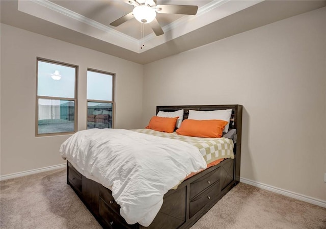 bedroom featuring crown molding, ceiling fan, a raised ceiling, and light carpet