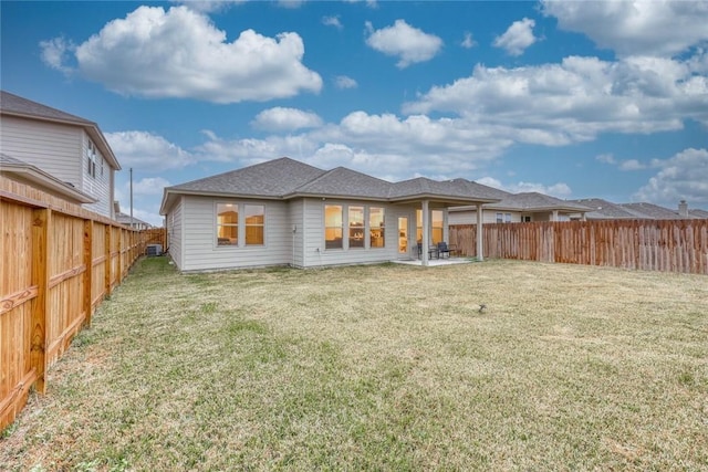 back of property featuring a yard and a patio