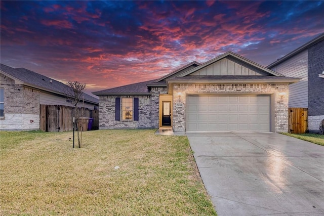 view of front of house with a garage and a lawn