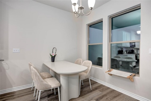 dining space with a notable chandelier and hardwood / wood-style flooring