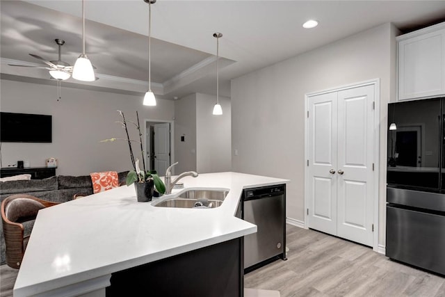 kitchen with sink, an island with sink, white cabinets, decorative light fixtures, and stainless steel dishwasher