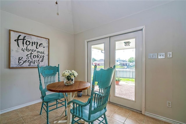 7410 Lake Micala Dr, Corpus Christi, TX 78413 - dining room with lofted ceiling, french doors, light tile patterned floors, and a water view