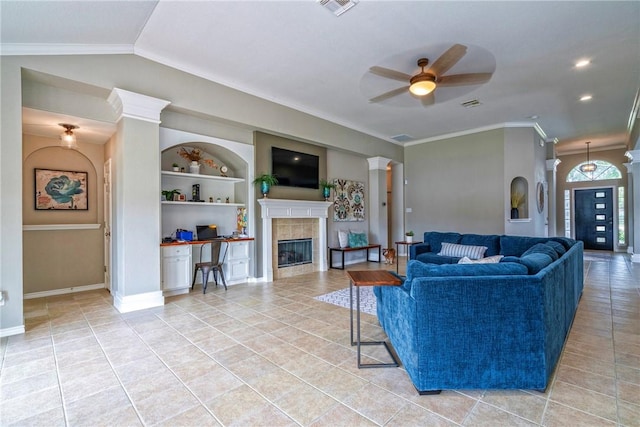 7410 Lake Micala Dr, Corpus Christi, TX 78413 - living room featuring a tile fireplace, a ceiling fan, light tile patterned floors, ornamental molding, and built in features