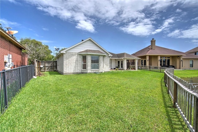 7410 Lake Micala Dr, Corpus Christi, TX 78413 - rear view of property featuring a fenced backyard and brick siding
