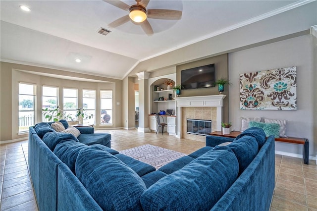 7410 Lake Micala Dr, Corpus Christi, TX 78413 - living area featuring built in features, vaulted ceiling, a ceiling fan, a tile fireplace, and light tile patterned floors