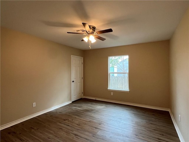 unfurnished room featuring ceiling fan and dark hardwood / wood-style flooring