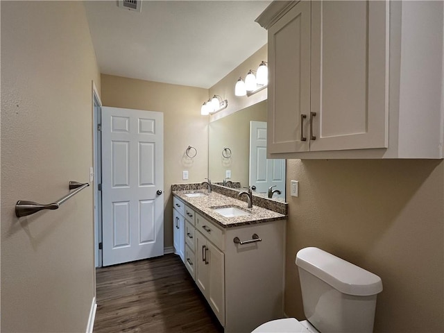 bathroom featuring vanity, toilet, and wood-type flooring