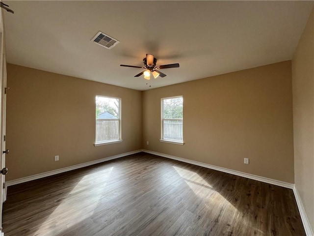 unfurnished room featuring ceiling fan and dark wood-type flooring