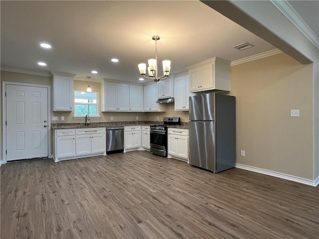 kitchen featuring white cabinetry, an inviting chandelier, pendant lighting, and appliances with stainless steel finishes