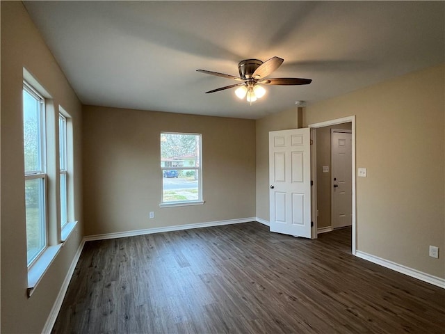 spare room with ceiling fan and dark wood-type flooring