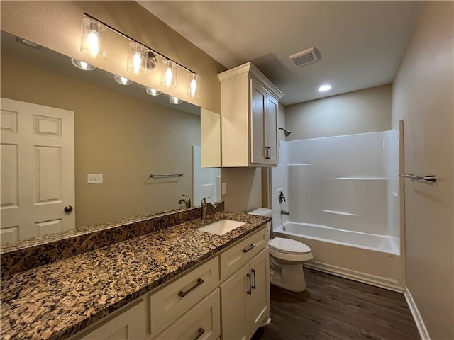 full bathroom with shower / tub combination, hardwood / wood-style floors, vanity, and toilet