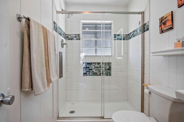 full bathroom featuring toilet and a shower stall