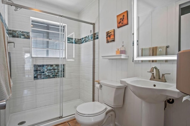 full bathroom featuring a stall shower and toilet