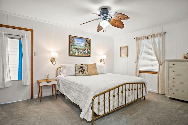 bedroom with ornamental molding, dark carpet, and ceiling fan