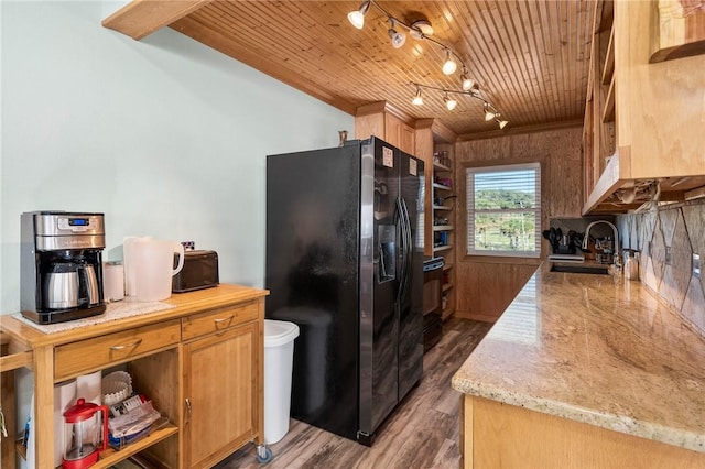 kitchen with dark wood-type flooring, black fridge, sink, and wood ceiling