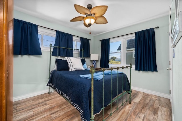 bedroom featuring hardwood / wood-style floors and ceiling fan