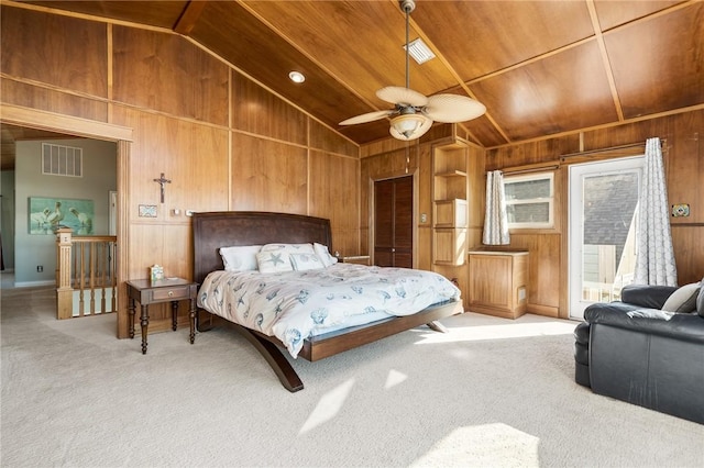 bedroom with light carpet, wood ceiling, ceiling fan, wooden walls, and lofted ceiling