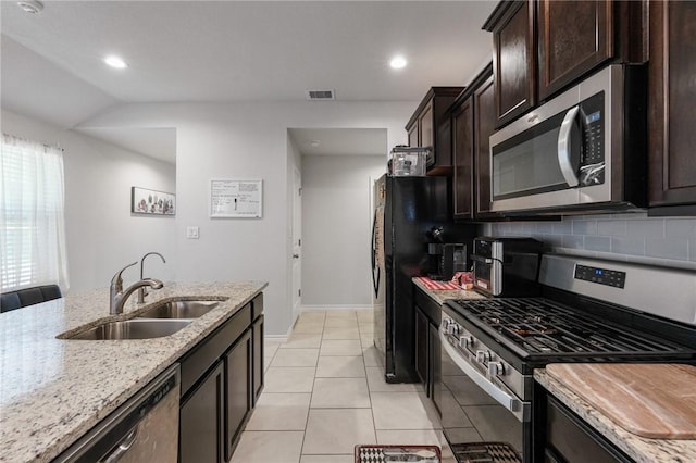 7606 Herd Rider, Corpus Christi, TX 78414 - kitchen featuring stainless steel appliances, a sink, tasteful backsplash, light stone countertops, and dark brown cabinets