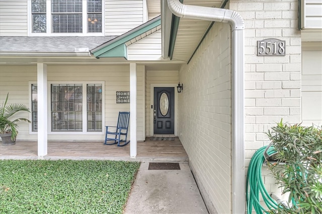 view of exterior entry with covered porch