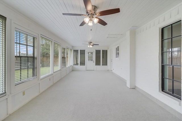 unfurnished sunroom with wood ceiling and ceiling fan