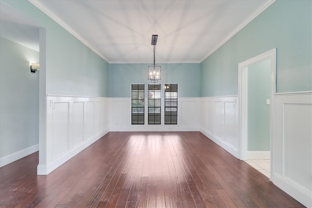 unfurnished dining area with wood-type flooring, a notable chandelier, and ornamental molding