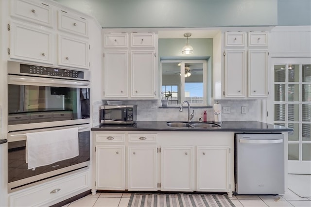 kitchen featuring white cabinets, light tile patterned floors, sink, and appliances with stainless steel finishes