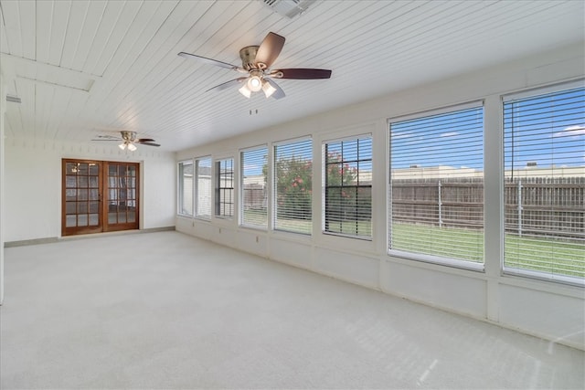 unfurnished sunroom featuring ceiling fan