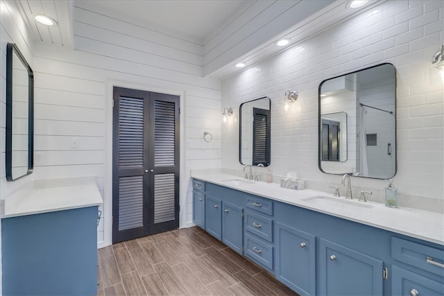 bathroom featuring wood walls and vanity