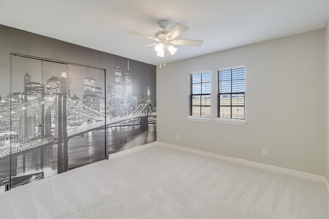 empty room featuring carpet flooring and ceiling fan