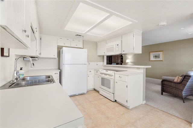 kitchen with sink, light colored carpet, white cabinets, and white appliances