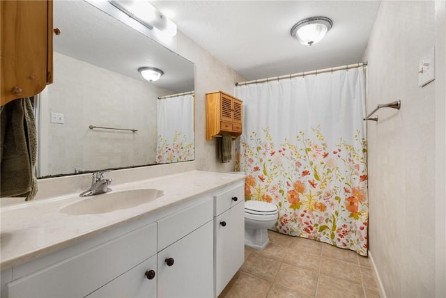 bathroom with vanity, tile patterned floors, and toilet