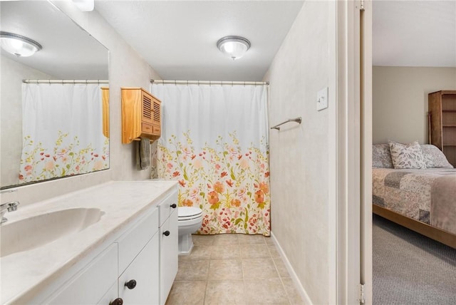 bathroom featuring tile patterned floors, toilet, and vanity