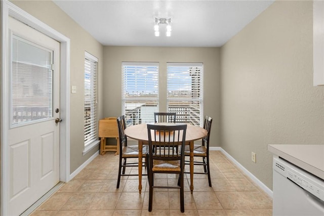 dining space featuring light tile patterned flooring